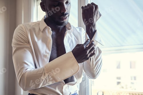 Preview: Man Fastening Cufflinks on Elegant White Shirt