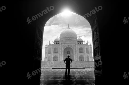 Preview: Rear view of man standing in archway near the Taj Mahal, Agra, India.