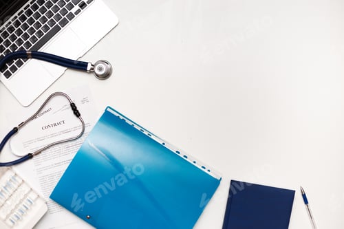 Preview: Medical Stethoscope on Laptop with Contract and Documents
