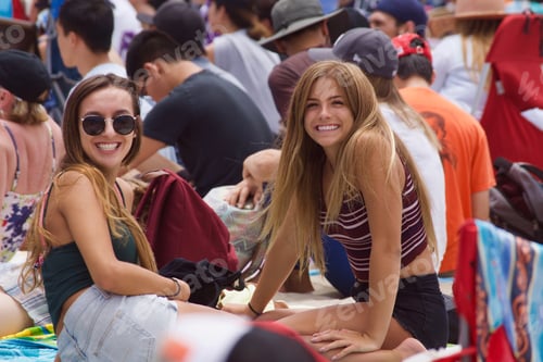 Preview: Two millennials happily waiting for the band to start at this outdoor