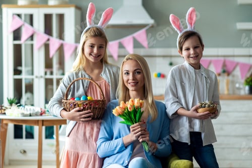 Preview: Portrait of happy family. Mother sitting and holding a bouquet of tulips
