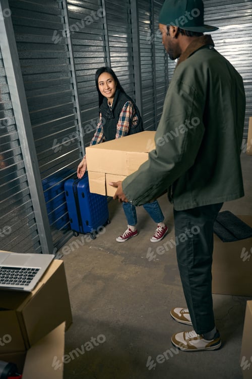 Preview: Two coworkers arranging goods in storage unit