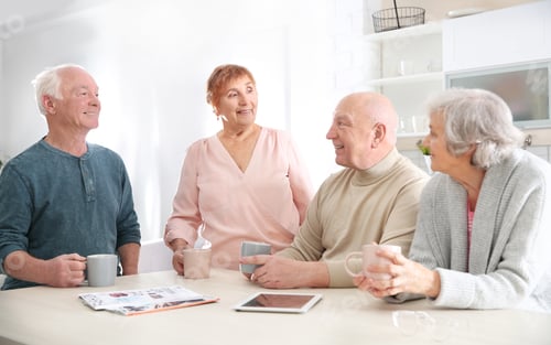 Preview: Elderly people spending time together at table in kitchen