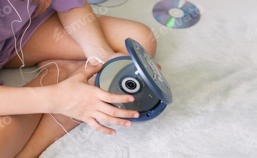 Preview: Girl connects headphones to CD player to listen to music. Recreation entertainment leisure teenager