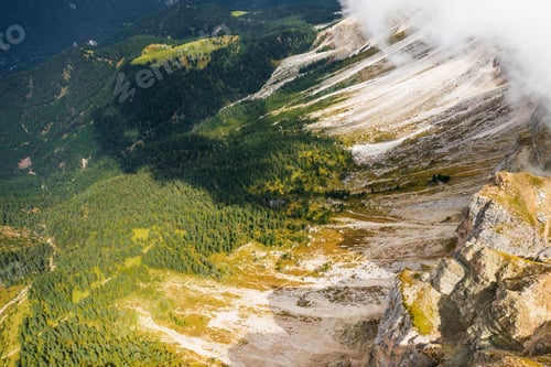 Preview: Aerial view of steep mountain slope with high spruce trees
