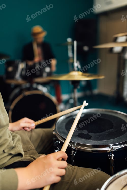 Preview: Drumsticks in the boy's hands. Drum lesson at a music school.