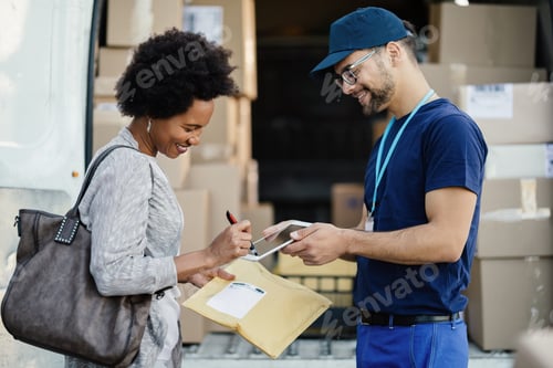 Preview: Happy African American woman signing on digital tablet for a package delivery.