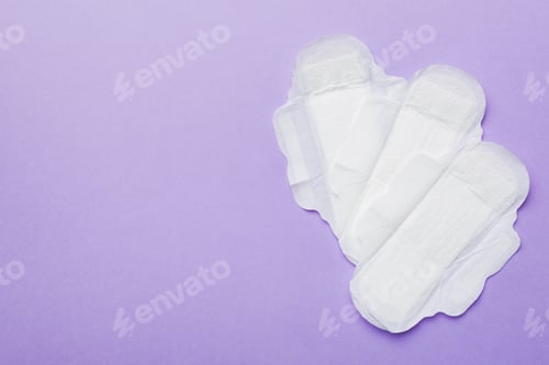 Preview: Women hygiene products or sanitary pad on colored background. Pastel color.