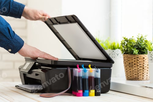 Preview: Man's hand making copies. Working with printer