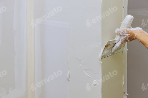 Preview: Hand of worker using gypsum plaster coating plaster walls construction