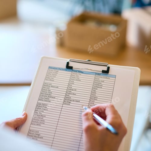 Preview: Close Up Of Female Charity Worker With Clipboard Checking Donations At Foodbank Or Thrift Store