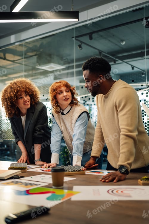 Preview: Interracial ecology experts at boardroom discussing renewable energy.