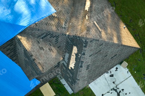 Preview: Hurricane Ian damaged house rooftop covered with protective plastic tarp against rain