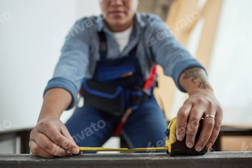 Preview: Female Worker Holding Tape Measure Close Up