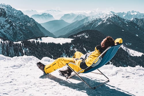 Preview: Man in snowy Italy Trentino Alps sunbed chair in Pinzolo