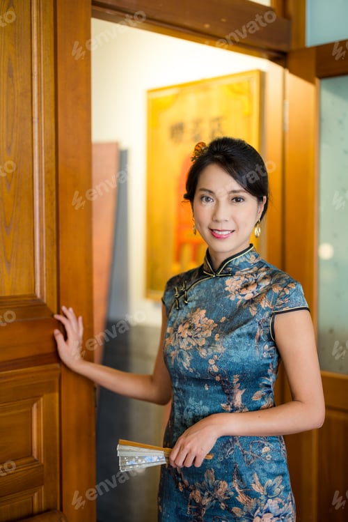 Preview: Woman wear traditional chinese cheongsam and smile to the camera