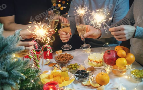 Preview: Champagne in hand against the background of the Christmas tree. People. Selective focus.