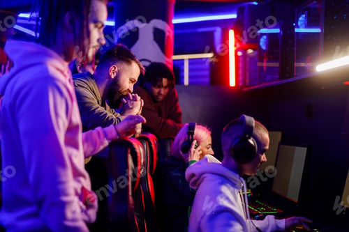 Preview: Team of gamers in internet cafe playing online video game on esport tournament