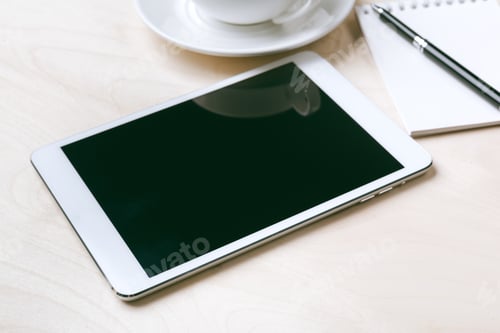 Preview: Digital tablet computer and cup of coffee on wooden desk