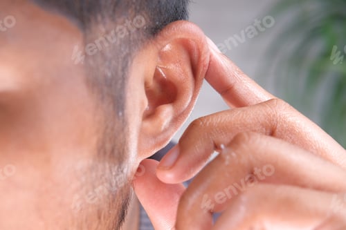 Preview: close up of young man holding ear suffering pain