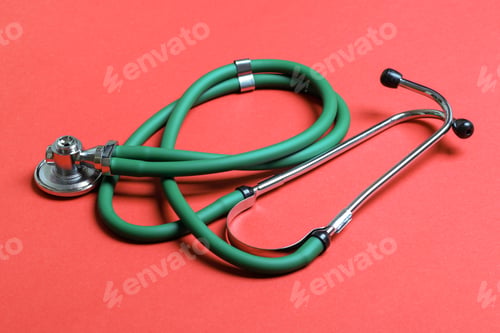 Preview: Top view of green stethoscope on colorful background. Medical diagnosis tool concept