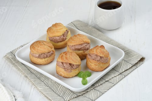 Preview: Choux pastry or Cream puffs filled chocolate custard.white background