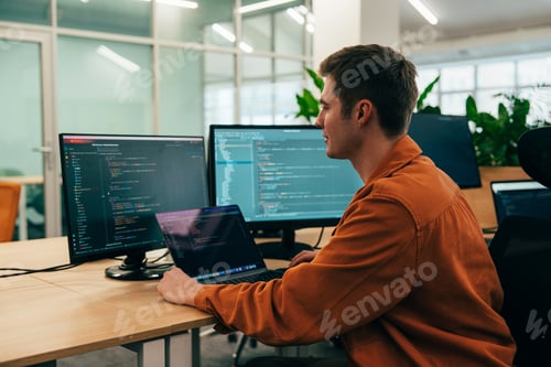 Preview: young programmers working on a new project for a start up business.