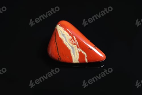 Preview: Beautiful red and white jade gemstone on black background