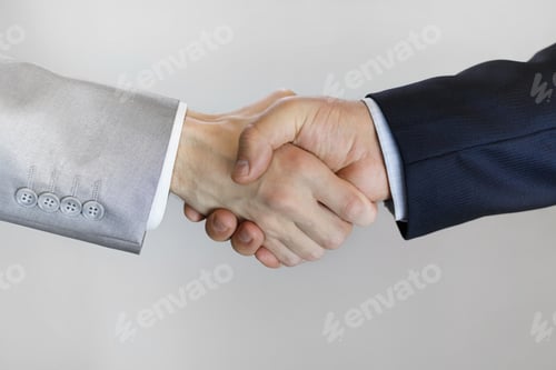 Preview: handshake of men in business suits close up