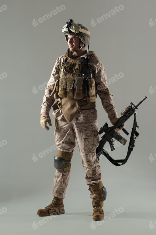 Preview: Soldier stands with weapon in neutral studio setting for display purpose