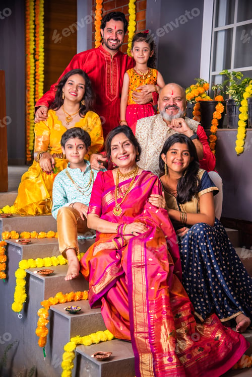 Preview: Indian family in traditional attire taking a group selfie on steps in Diwali or festival celebration