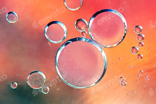 Preview: Abstract oil bubbles on an orange-red background. Macro photography of bubbles on the water surface.