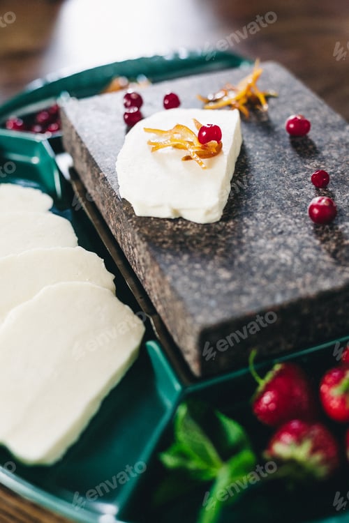 Preview: Mozzarella cheese in wooden bowl on white rustic table top view. Soft italian cheese