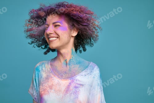 Preview: Carefree woman in Holi powder and with flying hair