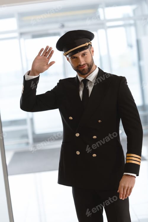 Preview: handsome young pilot waving at camera