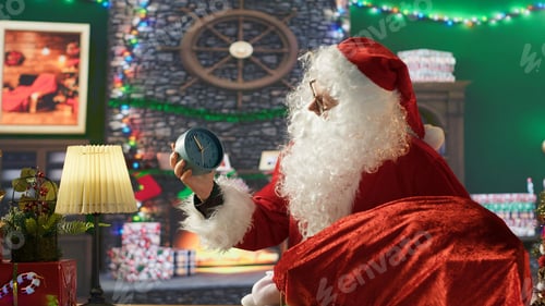 Preview: Saint Nicholas emphasizing Christmas eve with a wall clock in his festive cabin