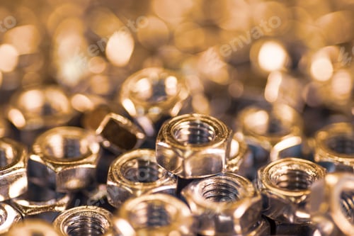 Preview: Metal chrome nuts in a chaotic order industrial background