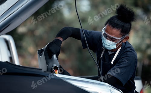 Preview: Car mechanic open car hood repairs system checking oil motor level for refill and clean in car garag