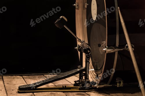 Preview: percussion instrument, bass drum with pedal on wooden boards with a black background