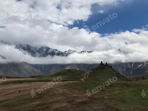 Preview: ancient temple against the backdrop of mountains in the clouds