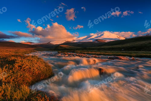 Preview: The picturesque mountain landscape with a creek at sunset sky background.