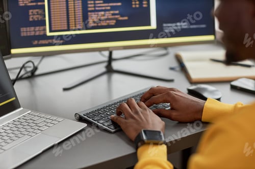 Preview: Close up of unrecognizable black man typing at keyboard while writing code