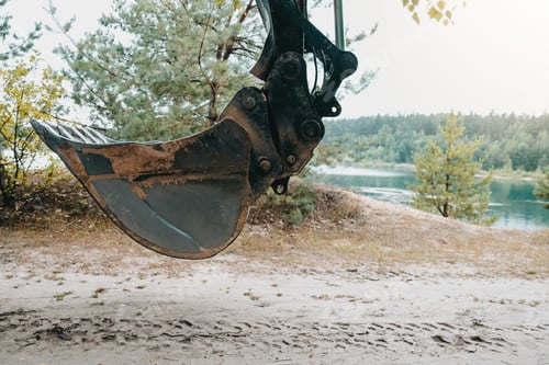 Preview: Large bucket on construction site or quarry. Mining heavy machinery details.