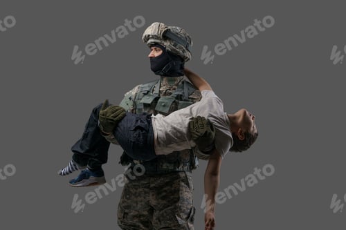 Preview: Brave soldier patriot carrying injured kid against grey background
