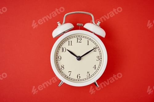 Preview: White retro alarm clock on the red background with copy space. Time concept