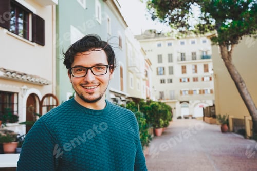 Preview: Smiling young man against a urban scene