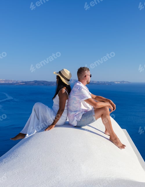 Preview: Men and women visit the whitewashed Greek village of Oia Santorini, couple watch sunrise Santorini