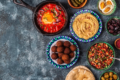 Preview: Falafel, hummus, shakshuka, Israeli salad - traditional dishes of Israeli cuisine.