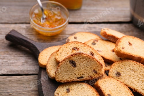 Preview: Sweet hard chuck crackers with raisins on wooden table, closeup