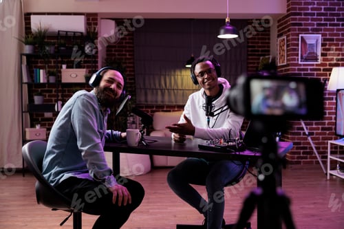 Preview: Male influencer using camera to record podcast conversation